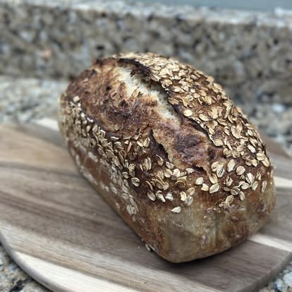 A honey oat loaf on a cutting board.