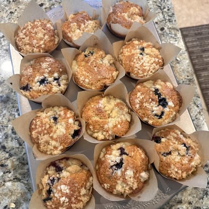 A tray of fresh blueberry muffins.
